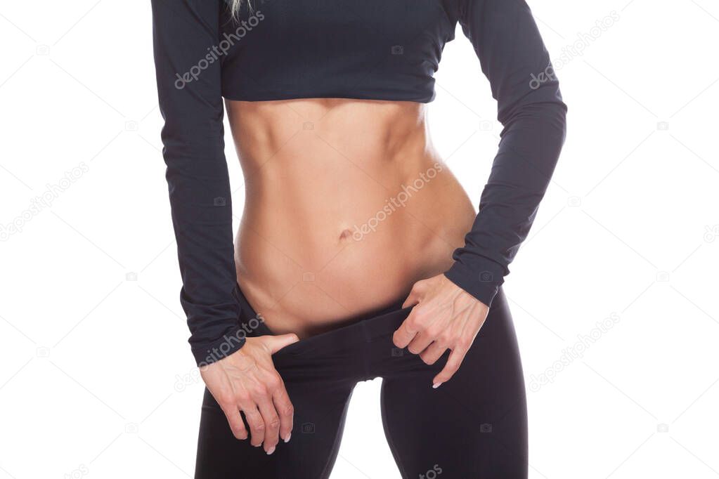 Close up of the muscular abdomen of a female athlete isolated on white background