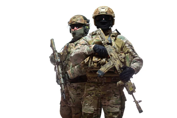 Portrait of two soldiers in camouflage, unloading vests, helmets and balaclavas, one standing behind the other, armed with machine guns waiting for the command to attack, isolated on white background — Fotografia de Stock