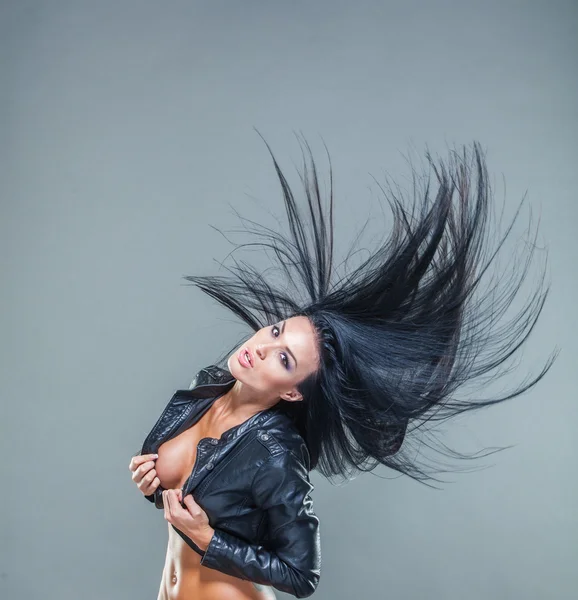 Beautiful girl exy breasts in unbuttoned jacket with long black hair, developing hair — Stock Photo, Image