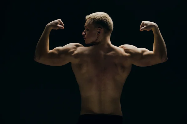 Close up of sports mans muscular isolated on black background — Stock Photo, Image