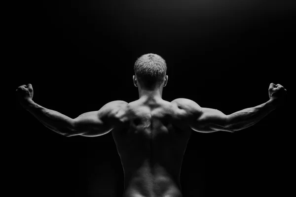 Close up of sports mans muscular isolated on black background — Stock Photo, Image