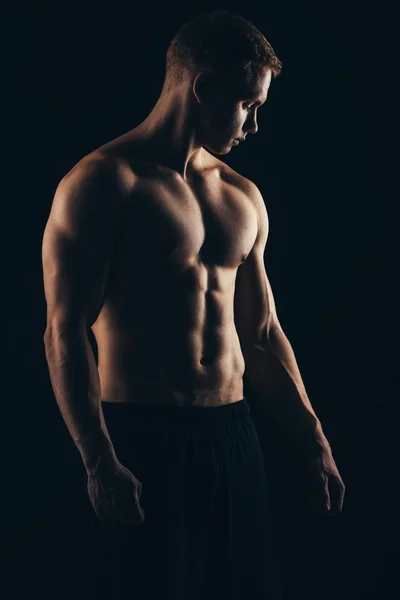 Close up of sports mans muscular isolated on black background — Stock Photo, Image