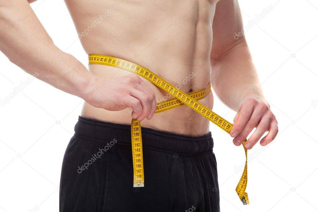 Athletic young man measuring his body belt.