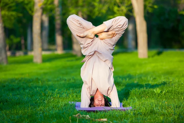 Practicing yoga in the morning, with trees  background — Stock Photo, Image