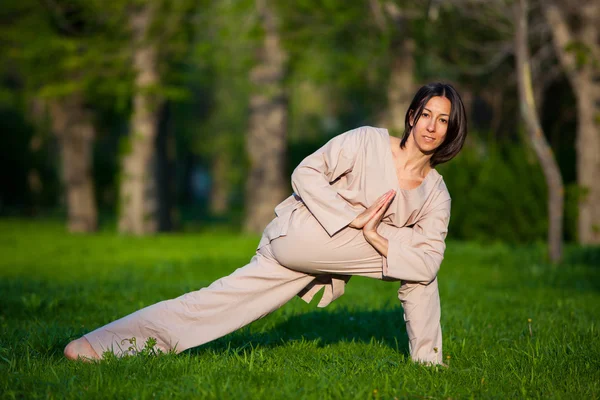 Practicing yoga in the morning, with trees  background — Stock Photo, Image