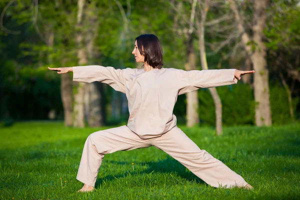Berlatih yoga di pagi hari, dengan latar belakang pohon — Stok Foto