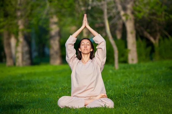 Practicar yoga por la mañana, con fondo de árboles — Foto de Stock