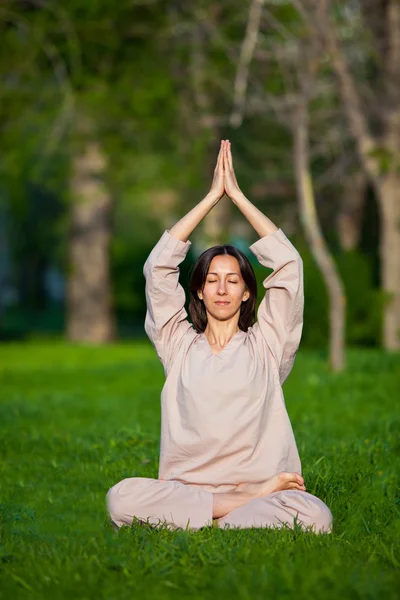 Practicing yoga in the morning, with trees  background — Stock Photo, Image