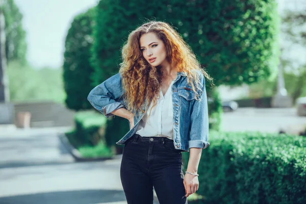 Beautiful young Caucasian girl with curly hair outdoors — Stock Photo, Image