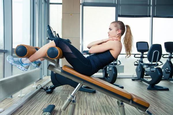 Mulher esporte bonito fazendo exercício de fitness imprensa no ginásio — Fotografia de Stock