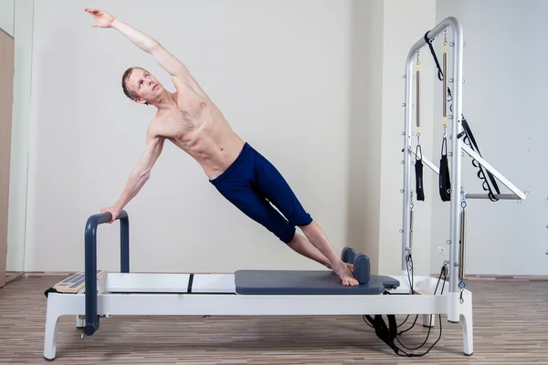 Pilates reformer workout exercises man at gym indoor — Stock Photo, Image