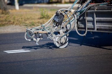 Teamwork: Pavement Asphalt Road Marking Paint and Striping with Thermoplastic Spray Applicator Machine during highway construction works