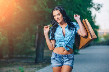 Portret van een vrolijke jonge vrouw met shopping tassen