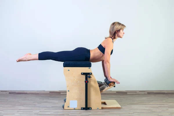 Combo wunda pilates chair woman fitness yoga gym exercise — Stock Photo, Image