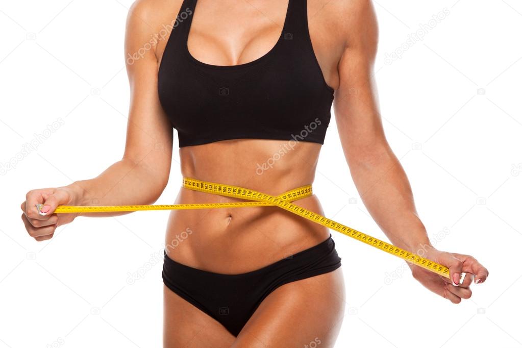 Beautiful sporty woman body with yellow measure on white background