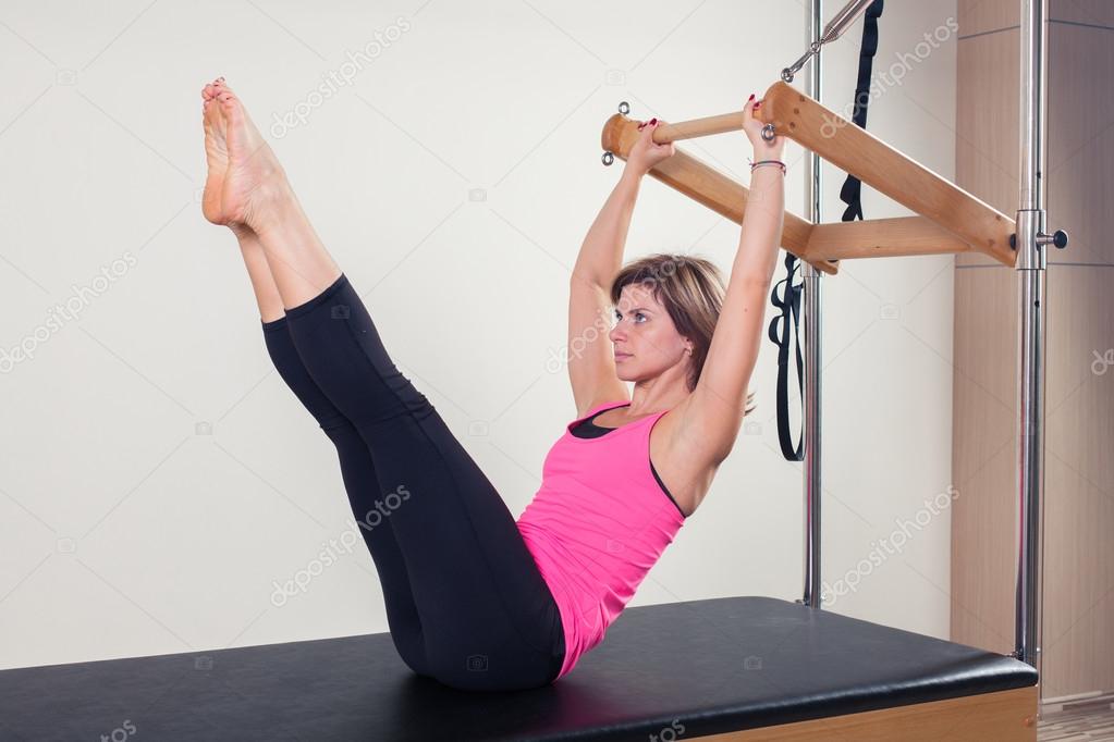 Pilates aerobic instructor woman in cadillac fitness exercise
