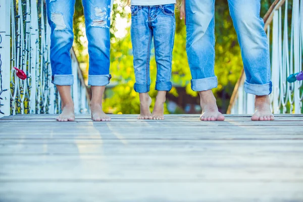 Happy Family on a Walk in Summer. Child with Parents Together. Feet Barefoot. Healthy Lifestyle. Dad Mom and Son. Spring Time