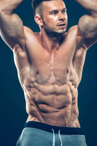 Sterke atletische Man Fitness Model Torso weergegeven: zes pack abs. geïsoleerd op zwarte achtergrond met copyspace — Stockfoto