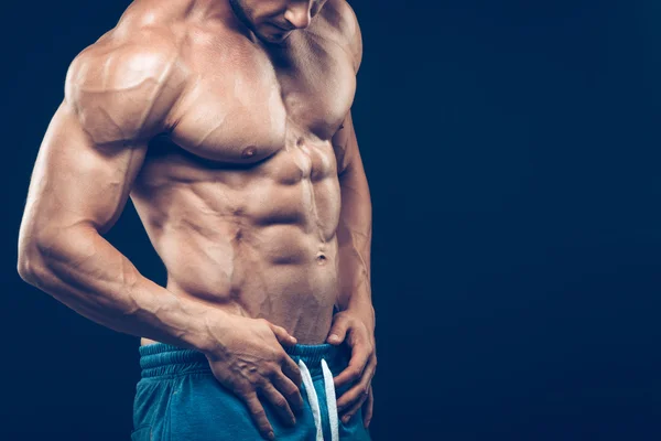 Strong athletic man on black background — Stock Photo, Image