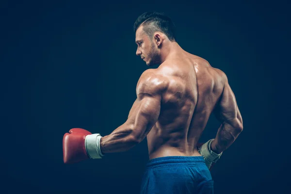 Muskulöser Boxer im Studio, auf schwarzem Hintergrund. — Stockfoto