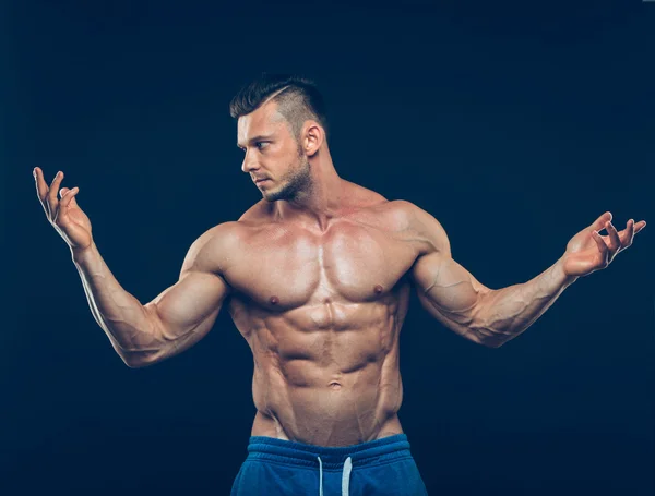 Strong athletic man on black background — Stock Photo, Image