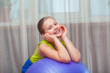 Child  with  on the ball for fittnesa at home
