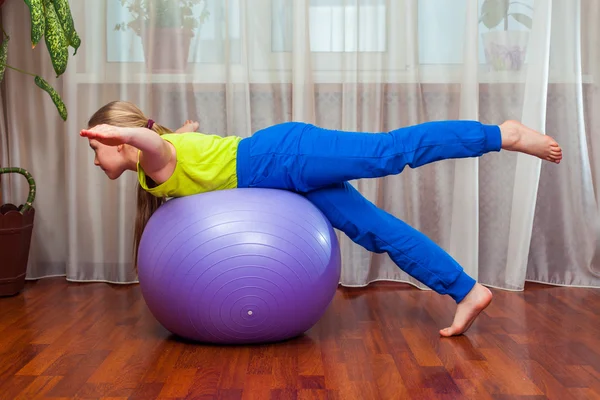 Child  with  on the ball for fittnesa at home — Stock Photo, Image