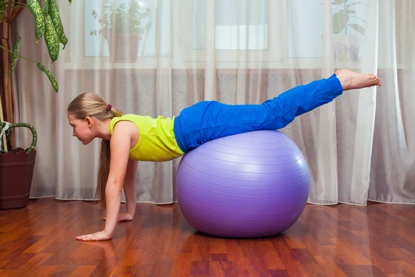 Child  with  on the ball for fittnesa at home — Stock Photo, Image