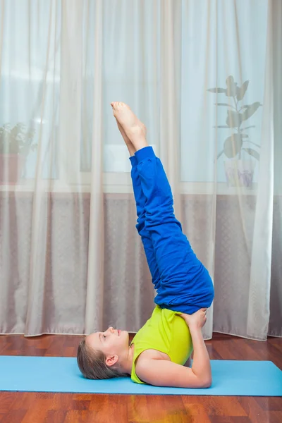 Fitness. sport, training and lifestyle concept - Child doing exercises on mat in home. — ストック写真