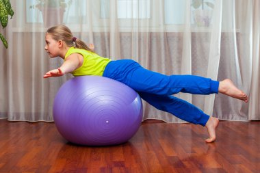Child  with  on the ball for fittnesa at home