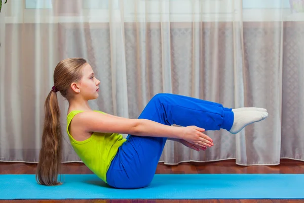 Fitness. sport, training and lifestyle concept - Child doing exercises on mat in home. — Stock Photo, Image