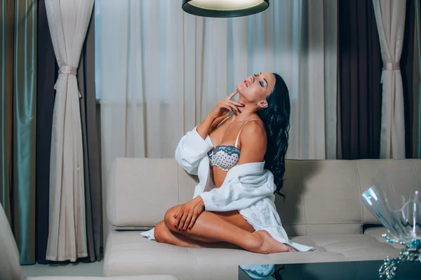 Beautiful young woman in white bathrobe  bedroom at home — Stock Photo, Image