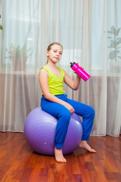 Child  with  on the ball for fittnesa at home Stock Image