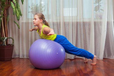 Child  with  on the ball for fittnesa at home