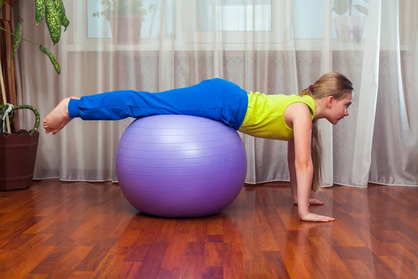 Child  with  on the ball for fittnesa at home — Stock fotografie