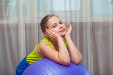 Child  with  on the ball for fittnesa at home