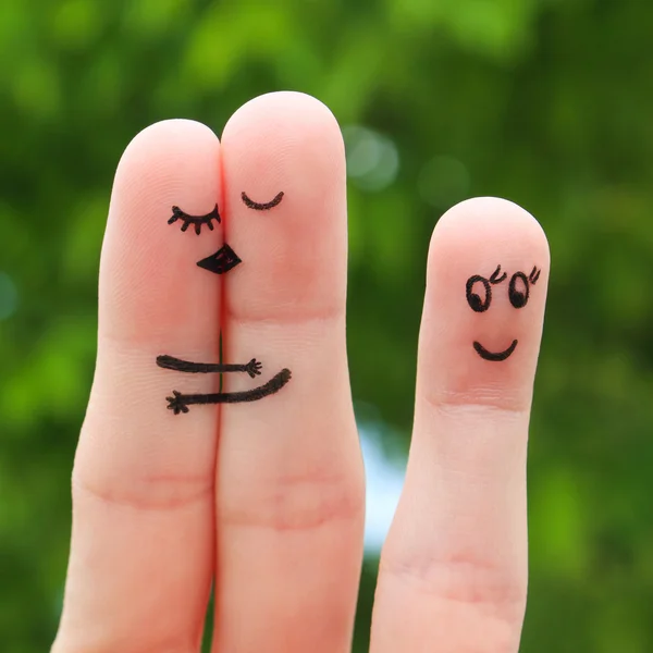 Finger art of a Happy couple. The happy couple kissing and hugging. The other girl looks at them and rejoices.