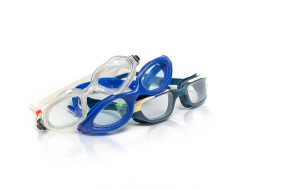 Swimming accessories on a white isolated background. Swimming goggles for swimming in the pool