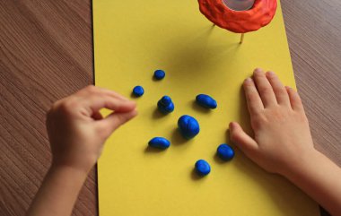 modeling of an alien for the day of cosmonautics from plastic mass with a flying saucer