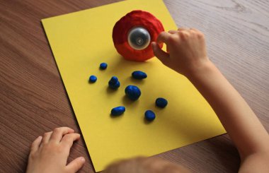 modeling of an alien for the day of cosmonautics from plastic mass with a flying saucer