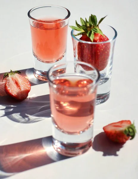 strawberry compote with ice in glass glasses with strawberries and ice cubes