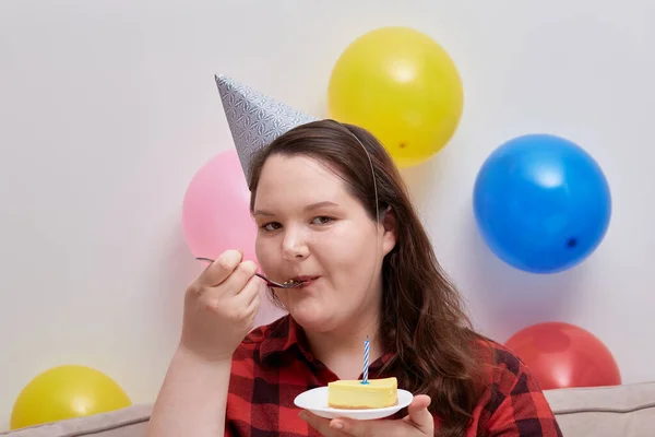 En ung kvinna njuter av en läcker dessert på sin födelsedag. — Stockfoto