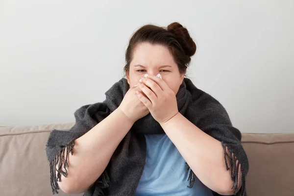 Una joven tiene gripe, un resfriado. Enferma sentada en casa. — Foto de Stock