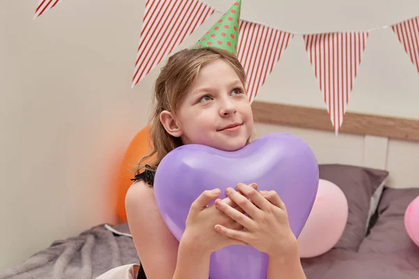 En vacker flicka håller ett hjärta - formad ballong i sina händer. — Stockfoto
