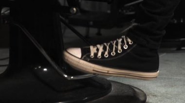 Bir adam berber koltuğunu kaldırır. Sandalyenin altı tozla kaplı..