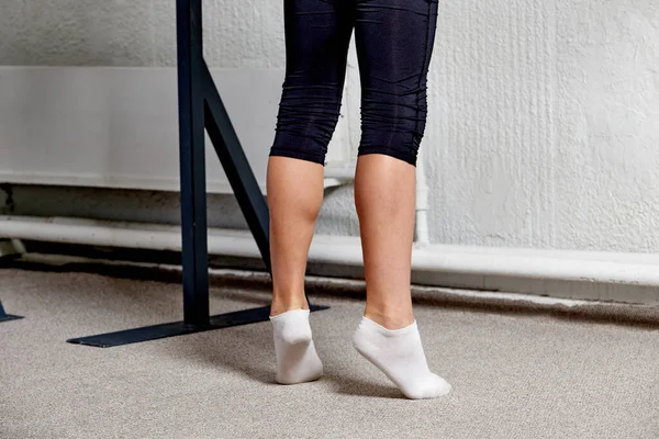 Men feet in white socks training before sports. Ballet classes. Coloured carpet.