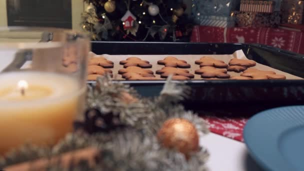 Il y a des biscuits au gingembre sur du papier parchemin. Arbre de Noël décoré de jouets. — Video