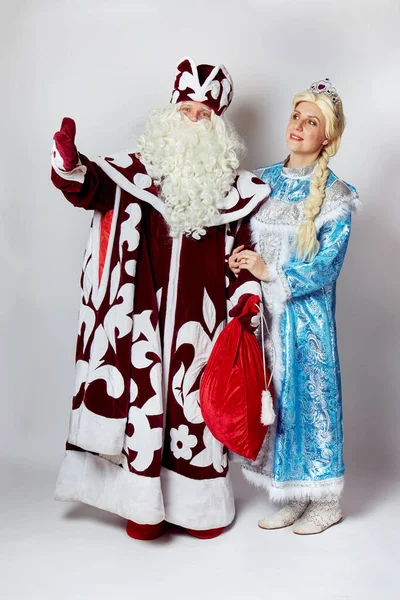 Санта Клаус со Снегурочкой в полном расцвете, костюмированная вечеринка. Белый фон. — стоковое фото