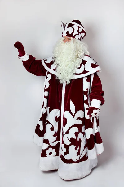 A fairy-tale hero with a long gray beard and a red fur coat with a white pattern — Stock Photo, Image