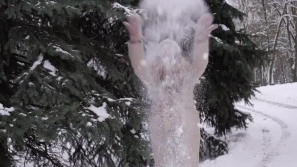 Una joven rubia vomita un gran bulto de nieve. Juegos de invierno. — Vídeo de stock